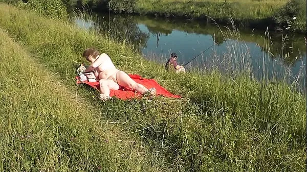Show Naked in public. Public nudity. Nudist beach. Wild beach. MILF sunbathing naked near fisherman new Clips